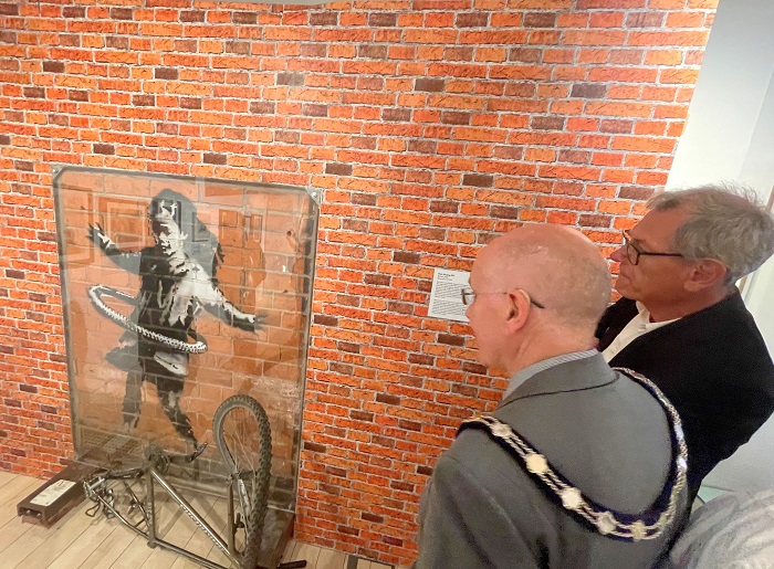 Cllr Pat Hanlon, Vice Chair of West Suffolk Council and Cllr Cliff Waterman, Leader of West Suffolk Council looking at Hula Hooping Girl by Banksy