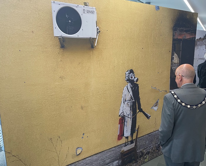 Cllr Pat Hanlon, Vice Chair of West Suffolk Council looks at one of the works Banksy painted in the Ukraine