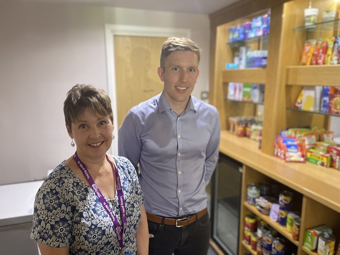 Cllr Donna Higgins, Cabinet Member for Families and Communities with John Gilbert from The Racing Centre, inside the community pantry.