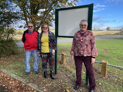 Wickhambrook Parish councillors Kevin Grimes and Andrea Grimes with West Suffolk Cllr Sarah Pugh, centre at the new parish noticeboard at Clopton Green icon