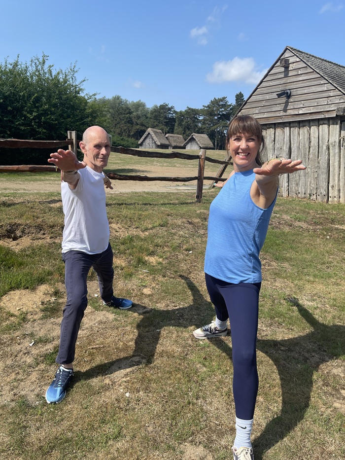 Robin Taylor and yoga instructor Tracey Clay perform warrior 2 pose 
