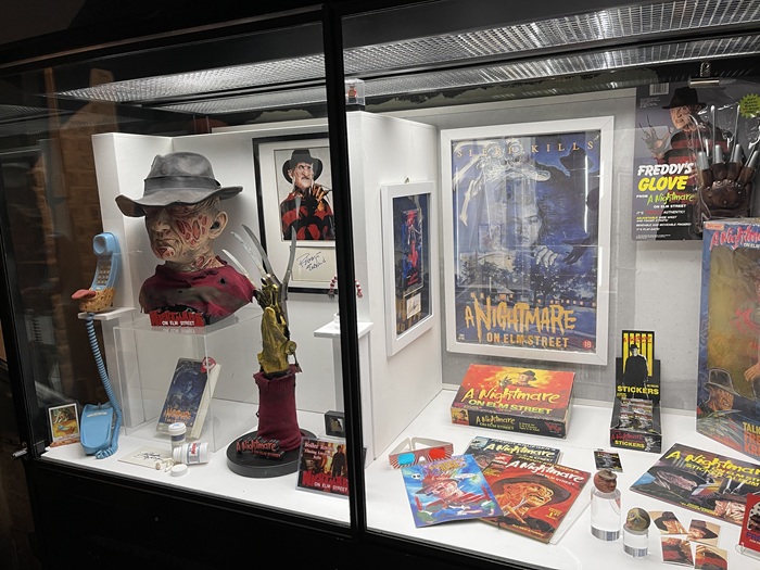 Things That Go Bump display featuring A Nightmare on Elm Street, including 80s memorabilia which took the character from screen menace to children’s toys and games. 