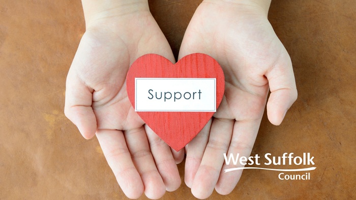 The word support is on a strapline across a red love heart being held by a pair of hands. West Suffolk Council's logo also features