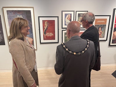 Hon Frances Stanley, Chairman of the Board of Trustees at the National Horseracing Museum with Cllr Pat Hanlon, Vice Chair and Cllr Cliff Waterman, Leader of West Suffolk Council viewing the work of the Connor Brothers at a Mutiny in Colour preview