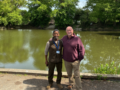 Two people in front of Hardwick Heath pond icon