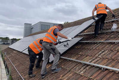 Solar panels being installed on a roof