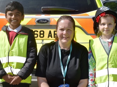 Two primary school children next to PC Cheryl Claydon