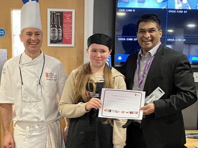 Student receiving award with Cllr Indy Wijenayaka and Chef Stuart Ascot icon