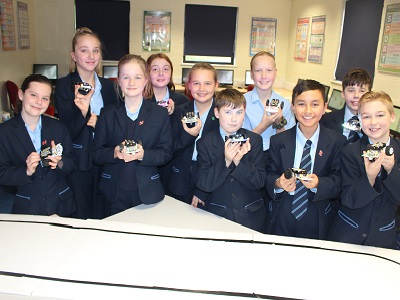 Newmarket Academy students with the robots that they have programmed