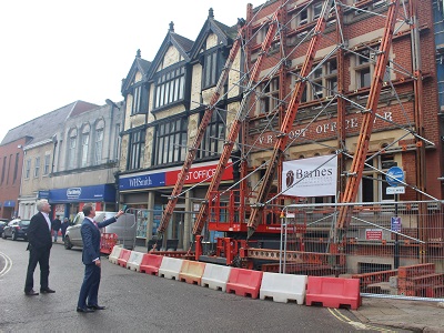 Mark Bailey, director at Barnes Construction outlines to Cllr John Griffiths, Leader of West Suffolk Council, the work to protect the Victorian Cornhill front.