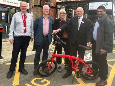 James Crameri, Station Supervisor, Greater Anglia, with Cllr Alexander Nicoll, Deputy Cabinet member for Transport Strategy, Suffolk County Council, Sara Noonan, Principal Growth Officer at West Suffolk Council, Alan Neville, Community and Customer Engagement Manager, Greater Anglia and Cllr Indy Wijenayaka, Cabinet Member for Growth, West Suffolk Council outside the new bike storage facility at Bury St Edmunds train station