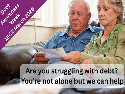 Are you struggling with debt - You’re not alone but we can help - the image shows a couple on a sofa with a bill in their hand, looking worried.
