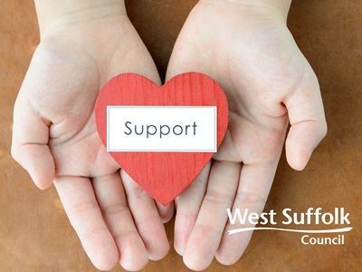 The image shows a pair of hands holding a red heart with the word support in black on a white strapline. West Suffolk Council's logo also features